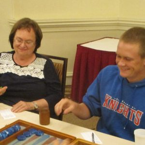 Karen Davis helps grandson learn and enjoy backgammon.